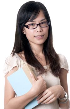 A young asian female holding a blue book while wearing glasses