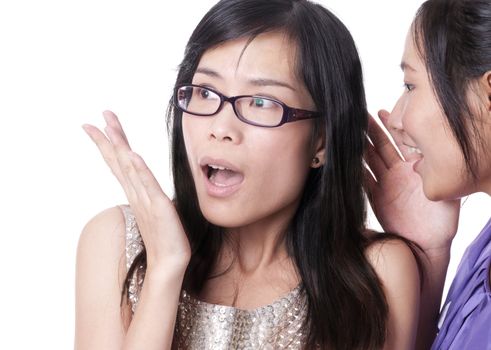 Girl telling a secret to another - gossip isolated over a white background