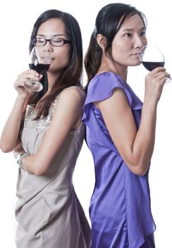 Two women next to each other in a bar having a drink