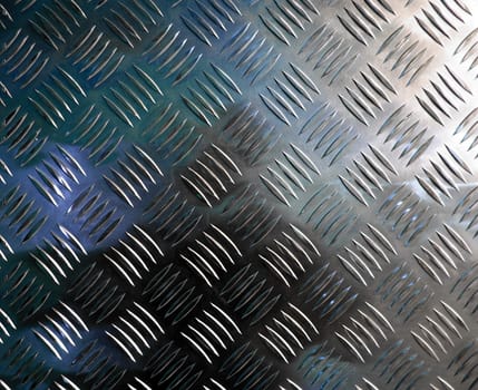 Diamond steel plate industrial iron metal background with blue light reflection