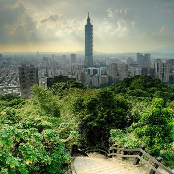 Dramatic cityscape of Taipei with famous landmark 101 skyscraper and trees in park, Taiwan, Asia.