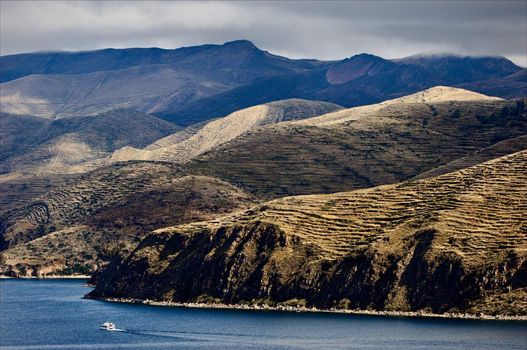 Bewitching kind from sun island on Titicaca lake  and the ship floating on him.