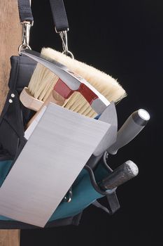 Stonemason's bag of tools on a black background.