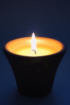 lit candle in the dark