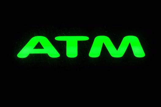ATM Neon Green Sign against dark background