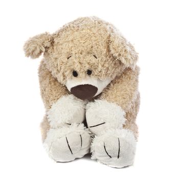 An adorable teddy bear that is sad and hurt.