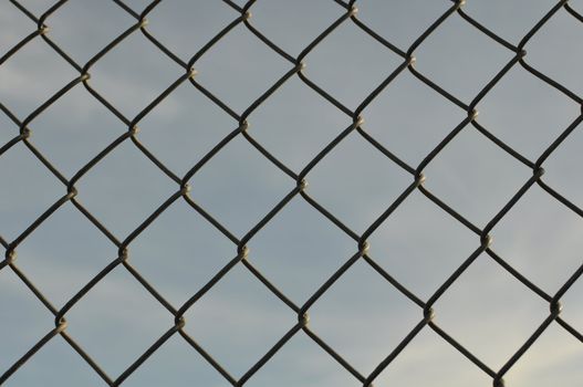 Chain Link Fence Background with Blue Sky
