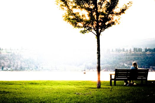 mountain sunset view across the lake from the bench