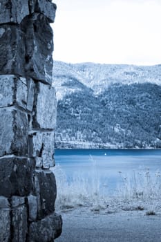 small white sail on the lake between two coasts