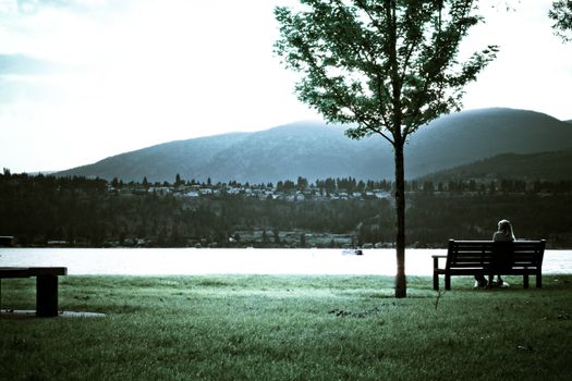 mountain sunset view across the lake from the bench