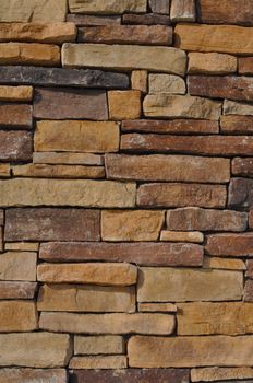 Wall of Multi Colored Stone used as a background