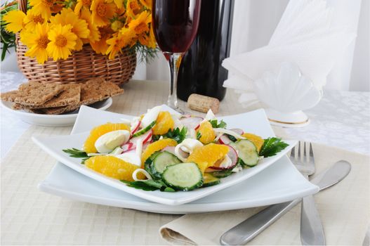 Salad of radish and cucumber with egg, cheese and orange