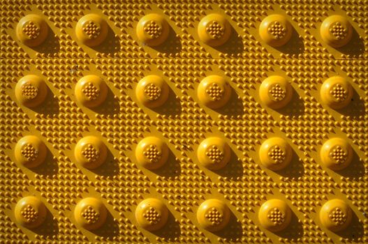 Yellow Repeating Knob Pattern used as a background to add text