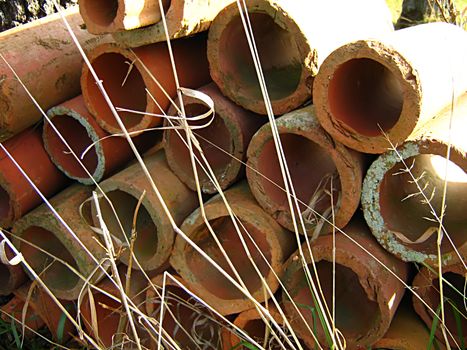 A photograph of clay pipes detailing their shapes and texture.