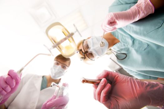 A dentist ready to drill on teeth, focus on the drill