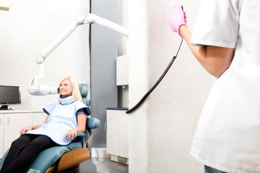 A dentist taking an x-ray of a patient