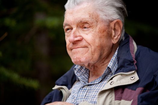 A portrait of an elderly man in the forest