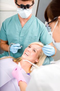 A woman at the dentist about to have some drilling done