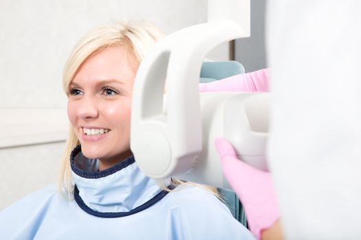 A woman having her teeth x-rayed 