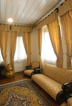 Living room, interior of home with chair and windows.