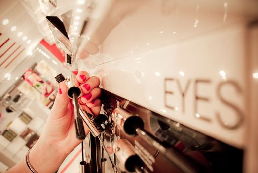 Young woman selecting make-up in a beauty store.