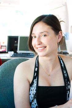 Attractive businesswoman with a natural smile, at work.