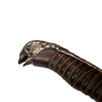 Ancient hawk sword handle isolated on white.