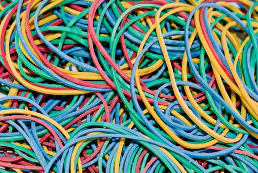 Background with a pile of colorful rubber elastics.