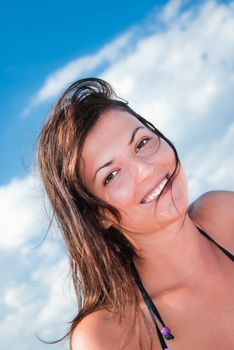 Young Woman over blue Sky at the seaside