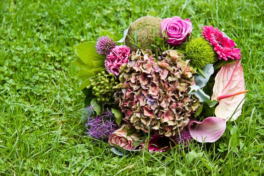 Bouquet with late summer flowers on grass background - horizontal