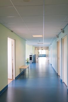 Long corridor in hospital with doors and reflections