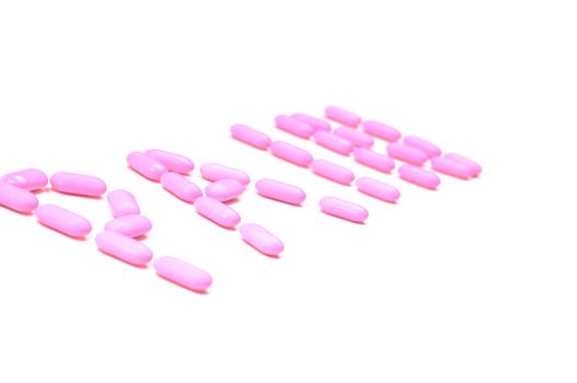 Shot of pink drugs (tablets) isolated on white