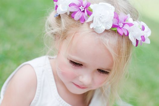 Little girl portrait with wreath, outdoor shooting