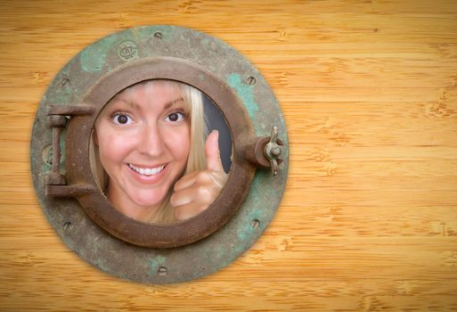 Antique Porthole on Bamboo Wall, Woman with Thumbs Up Looking Through Window.