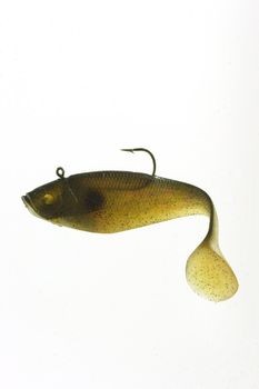 An artificial fishing lure floating against a white background