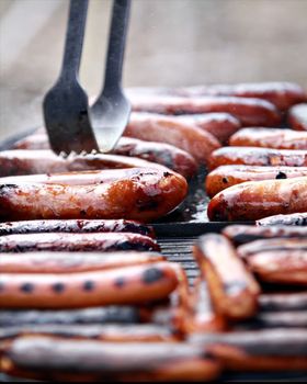 Hotdogs being grilled outside for a barbecue party