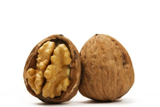 walnut and a cracked walnut on white background