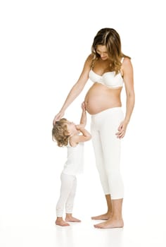 Pregnant woman with her daughter isolated on white background