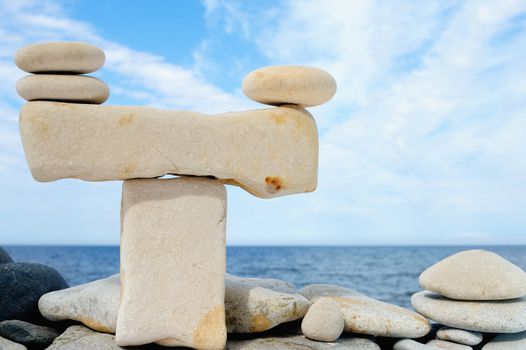 Balancing of white pebbles on the sea coast