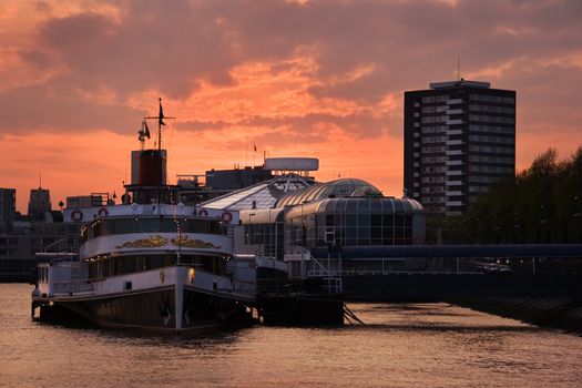 View on Rotterdam at sunset with paddle steamer "Majesteit" and tropical swimmingpool "Tropicana".