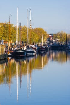 Ships in the harbor on a blue and golden Octobermorning