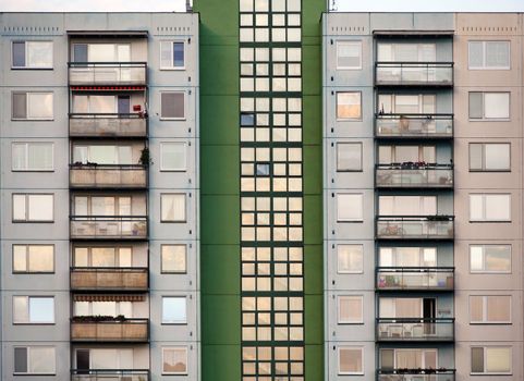 Green and grey prefab house with many balcons and windows