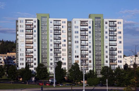 Green and grey prefab house with many balcons and windows