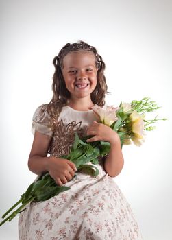 Cute little girl with pigtail hairstyle showing two missing teeth, studio shot  