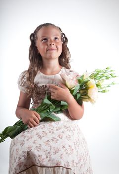 Little girl with flowers, studio shot  