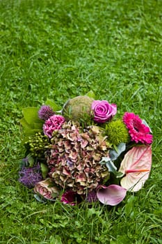 Bouquet with late summer flowers on grass background - vertical