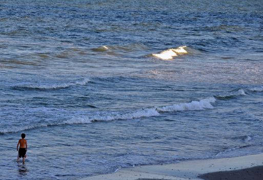 Boys sizes up the waves