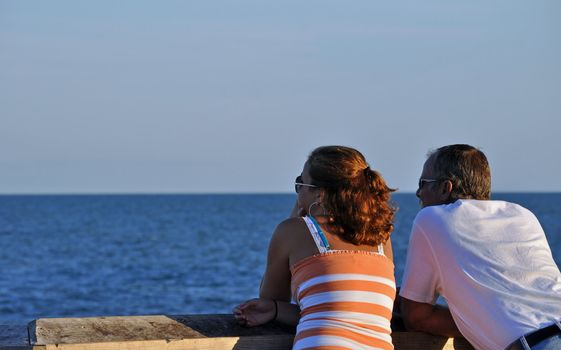 Couple stares out at the ocean