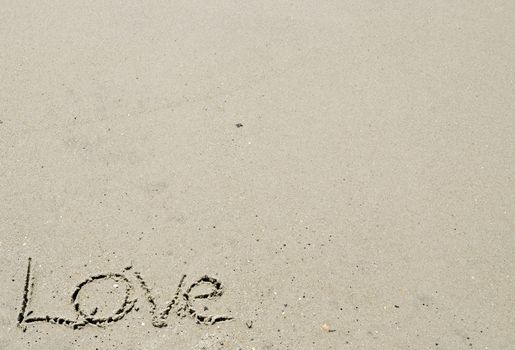 Love written in the sand - bottom left corner