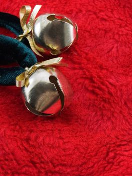 Gold christmas bells on a red plush fabric